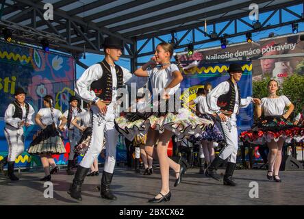 Slovakian dancers group called `Jurosik` perform traditional Slovakian dance on stage in traditional costumes called `Kroj`. Stock Photo